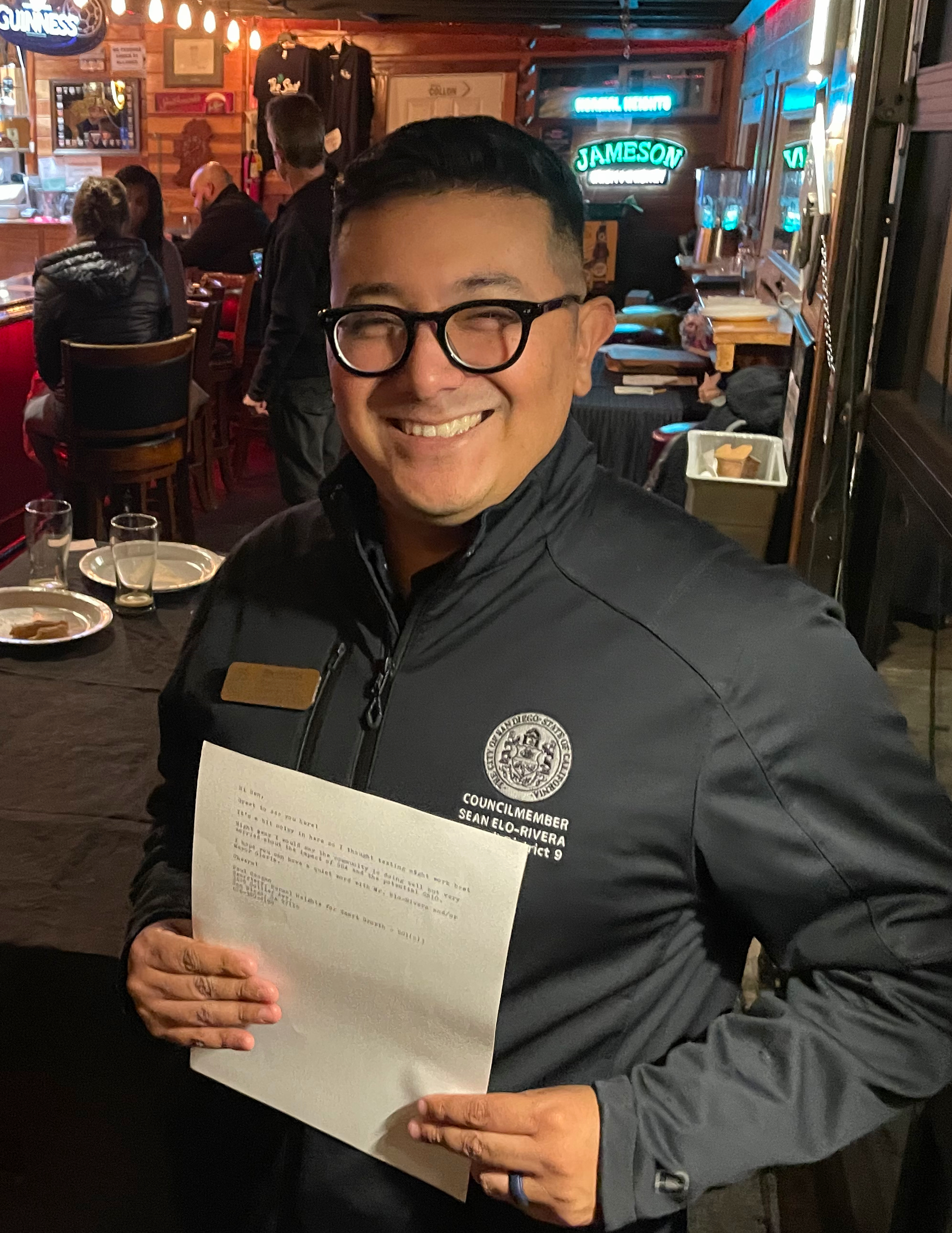 Ben Mendoza holding a message from the community at a recent mixer.